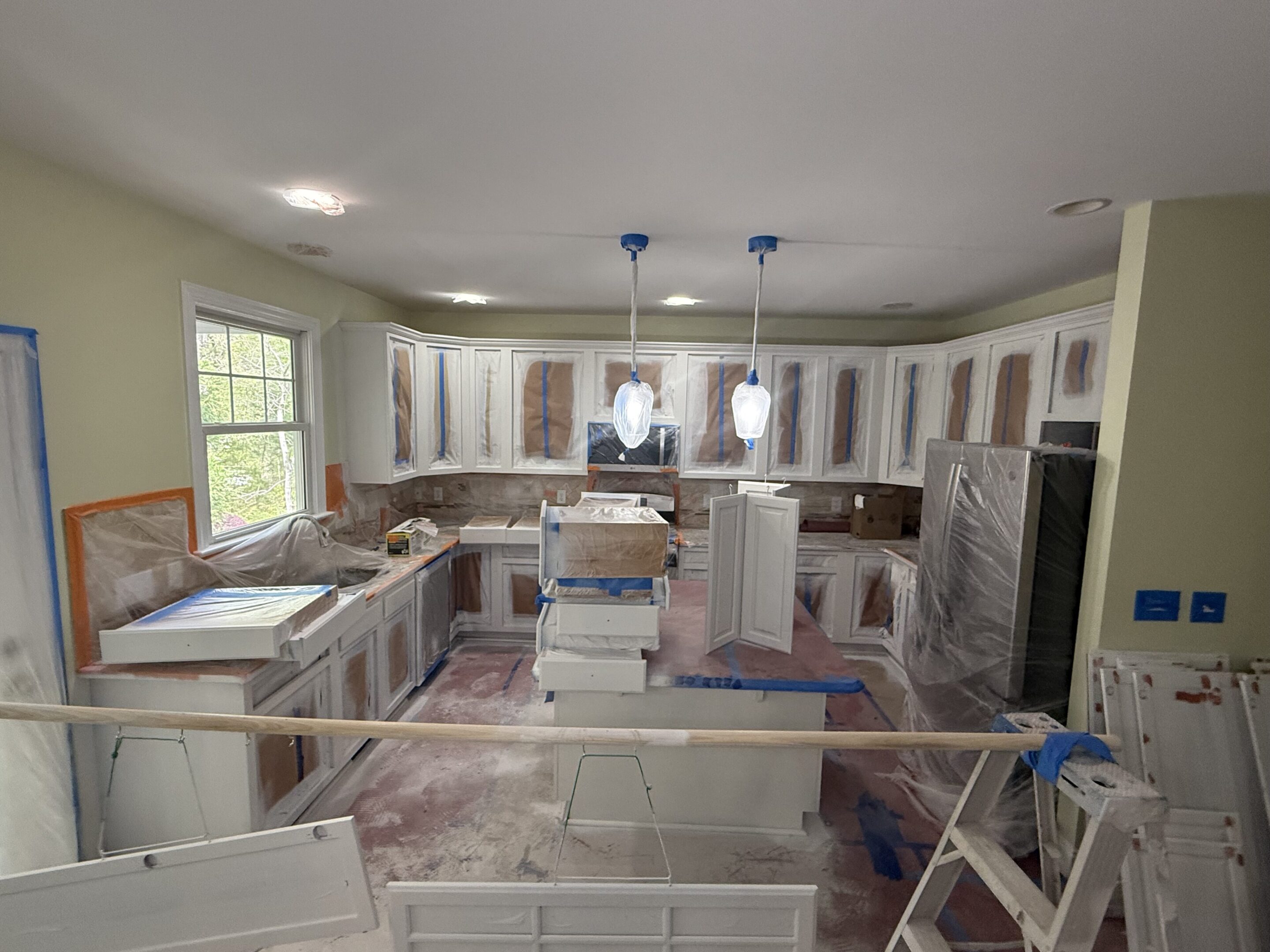 Kitchen under renovation with new cabinets being installed.