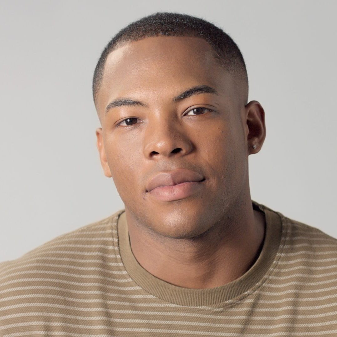 Man in striped shirt, neutral expression